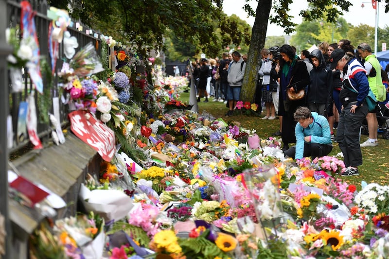 epa07444000 Members of the public place flowers at a makeshift memorial for the victims of the mosque mass murders at the Botanical Gardens in Christchurch, New Zealand, 17 March 2019. A gunman killed 50 worshippers at the Al Noor Masjid and Linwood Masjid on 15 March. A suspected gunman, 28-year-old Brenton Tarrant of Australia, has appeared in court on on the morning of 16 March and was charged with murder.  EPA/MICK TSIKAS  AUSTRALIA AND NEW ZEALAND OUT