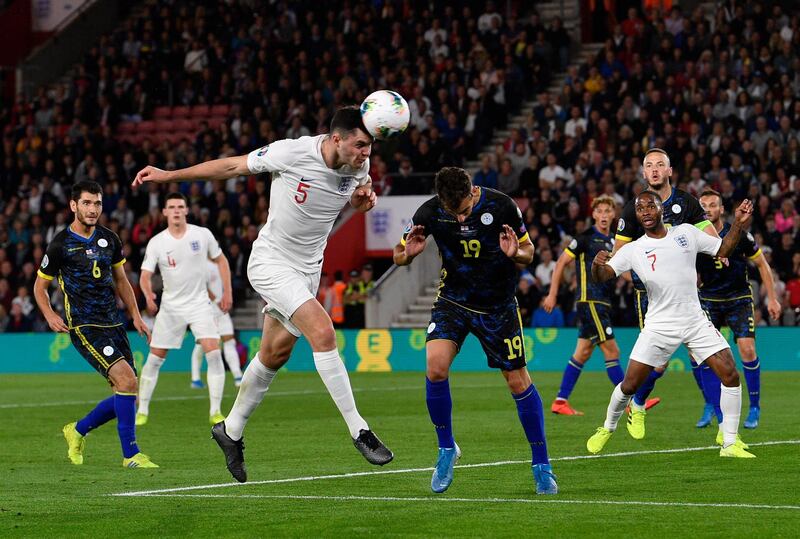 England's Michael Keane heads the ball. EPA