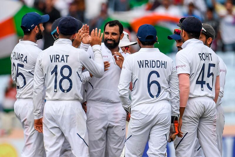 India's Mohammed Shami, centre, celebrates after taking the wicket of Zubayr Hamza. AFP