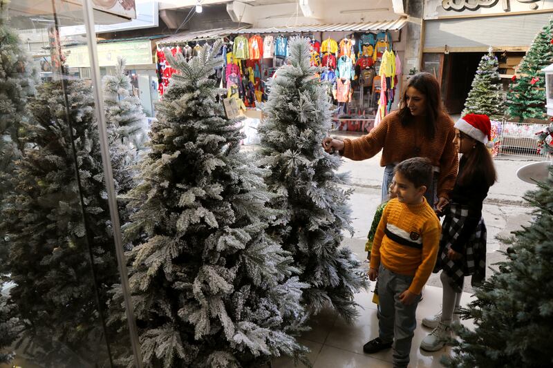 An Iraqi Christian family looks for Christmas decorations in Al Hamdaniya, Iraq. Reuters