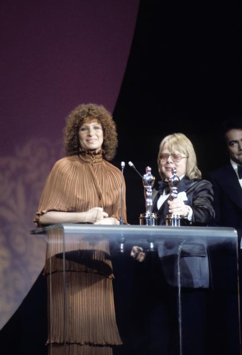 Barbra Streisand receives her Oscar for Evergreen, from A Star is Born, at the 1977 Academy Awards. ABC Photo Archives / ABC via Getty Images.