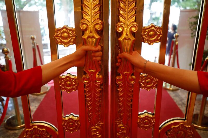 Staff open the doors of the Dolce Hanoi Golden Lake luxury hotel in Hanoi. Reuters