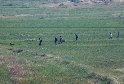 Israeli settlers search on Saturday for a boy who went missing near the Palestinian village of Al Mughayyir in the occupied West Bank a day earlier. Reuters