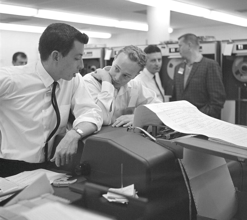 This archival image shows engineers at NASA's Jet Propulsion Laboratory looking at data related to the Venus flyby of Mariner 2 on Dec. 14, 1962. This was the first successful flyby of another planet.