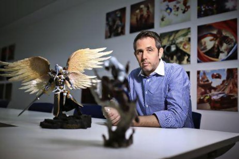Yannick Theler, the general manager at Ubisoft in Abu Dhabi, pictured at the company's UAE office, with a model of a character from the Final Fantasy video games. Sarah Dea / The National