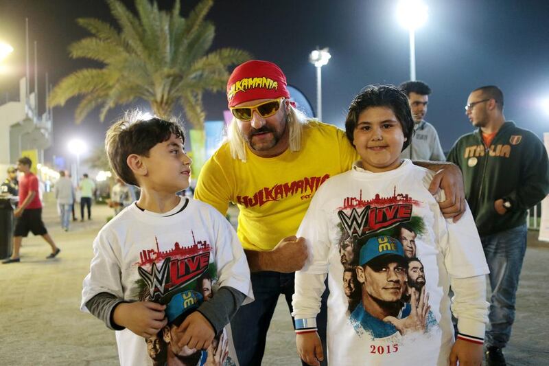 Osama Khalid, an expatriate from Syria dressed as Hulk Hogan poses with young fans. Christopher Pike / The National
