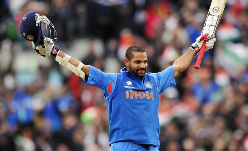 India's Shikhar Dhawan celebrates his century (100 Runs)  during the 2013 ICC Champions Trophy One Day International (ODI) cricket match between India and West Indies at The Oval in London, England on June 11, 2013.  India defeated the West Indies by eight wickets at the Oval to qualify for the Champions Trophy semi-finals, a result that knocked arch-rivals Pakistan out of the race.  AFP PHOTO/GLYN KIRK - RESTRICTED TO EDITORIAL USE
 *** Local Caption ***  319682-01-08.jpg