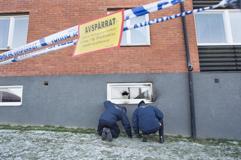 Police officers investigate a suspected arson attack after a fire in a mosque in the southern Swedish town of Eslov on December 29, 2014. Drago Prvulovic/AFP Photo

