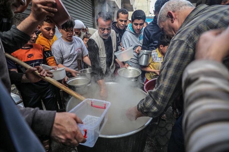 Palestinians gather to get soup offered for free during the Muslim holy month of Ramadan in Gaza City, Gaza Strip.  EPA