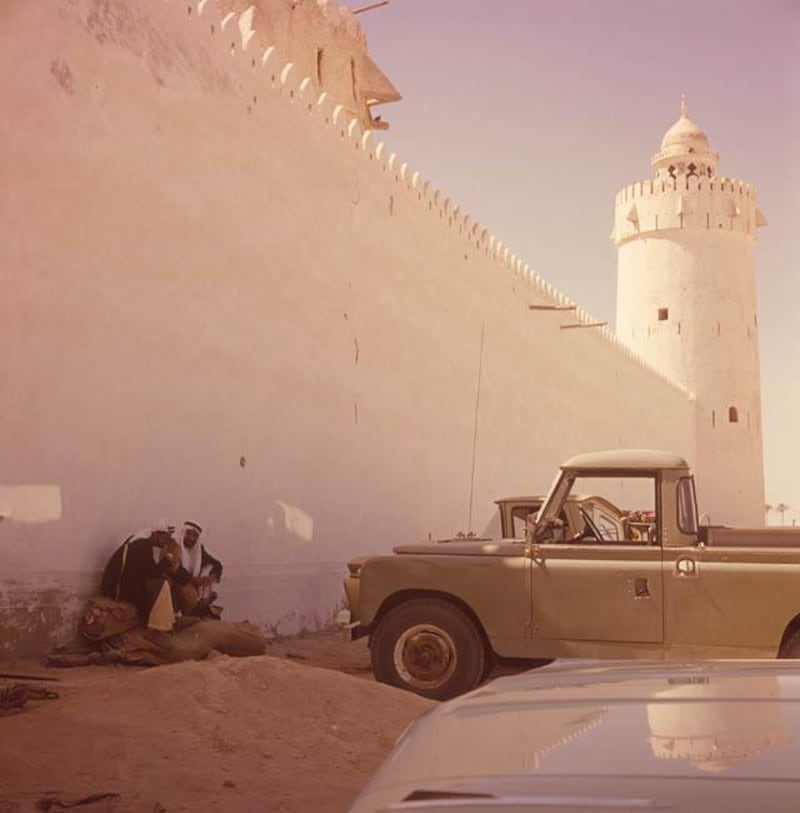 Archival photograph of the Trucial States shot by photographer Guy Gravett in the 1960s. Image shows Sheikh Zayed (right) sitting with an unknown man by the walls of Al Hosn fort in Abu Dhabi. 