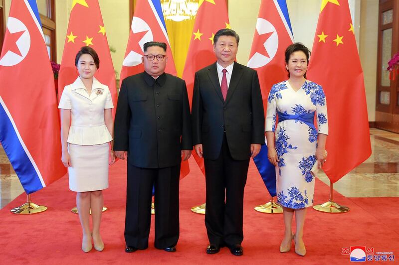 North Korean leader Kim Jong-un and his wife  and his wife Ri Sol-ju, left, pose for a photo with Chinese President Xi Jinping and his wife Peng Liyuan at the Great Hall of the People in Beijing, China.  KCNA / EPA