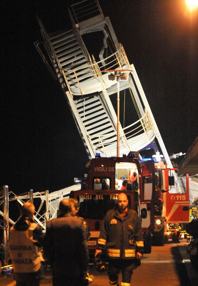 Rescuers search what is left of the toppled control tower of the port of Genoa, northern Italy, after a cargo ship slammed into it killing at least three people, Tuesday, May 7, 2013. A half-dozen people remain unaccounted for early Wednesday, after a cargo ship identified as the Jolly Nero of the Ignazio Messina & C. SpA Italian shipping line, slammed into the port. (AP Photo/Francesco Pecoraro) *** Local Caption ***  Italy Cargo Ship Crash.JPEG-0ae8f.jpg