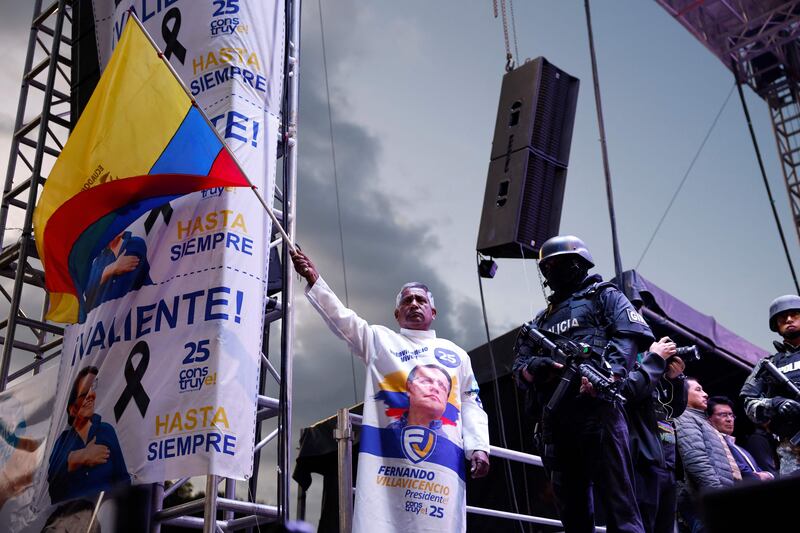 A priest waves an Ecuadorian national flag in Quito during the closing campaign rally of the Movement Construye party's presidential candidate Christian Zurita ahead of the August 20 election. AFP