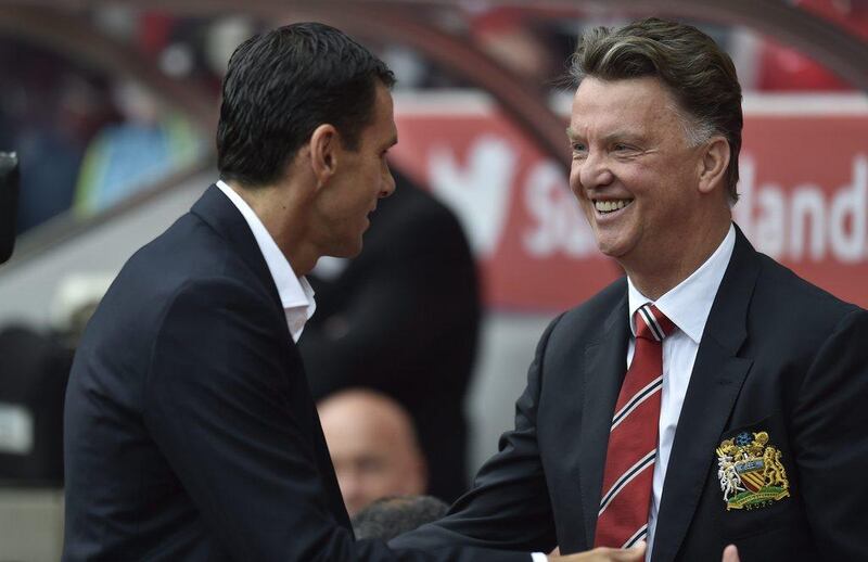 Manchester United manager greets Sunderland manager Gus Poyet before their Premier League match on Sunday. EPA Photo / August 24, 2014