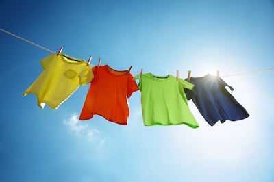 Airing clothes out under the sun is one way to eliminate odours and germs without washing. Getty Images