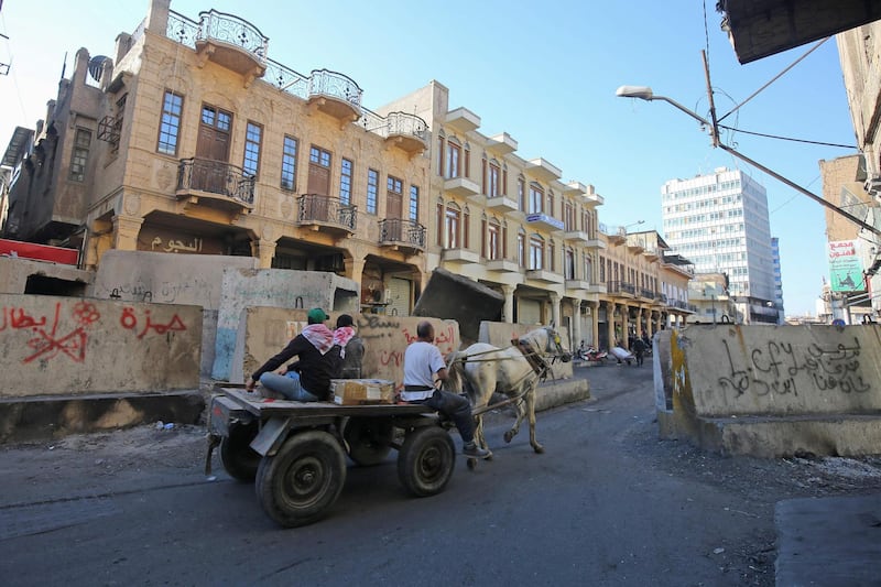 Iraqis ride a horse-drawn cart on Al Rashid street in the capital Baghdad amid ongoing anti-government demonstrations. AFP