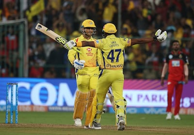 Chennai Super Kings' Dwayne Bravo, right, raises his arms to embrace captain Mahendra Singh Dhoni, left, after their win in the VIVO IPL Twenty20 cricket match against Royal Challengers Bangalore in Bangalore, India, Wednesday, April 25, 2018. Chennai Super Kings won the match by five wickets. (AP Photo/Aijaz Rahi)