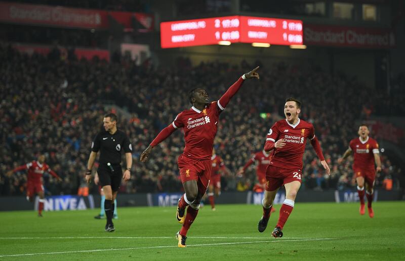 LIVERPOOL, ENGLAND - JANUARY 14:  Sadio Mane of Liverpool celebrates with team mate Andy Robertson after scoring the third Liverpool goal during during the Premier League match between Liverpool and Manchester City at Anfield on January 14, 2018 in Liverpool, England.  (Photo by Shaun Botterill/Getty Images)