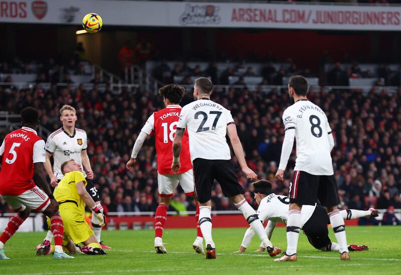 Manchester United's Lisandro Martinez scores their second goal past Arsenal's Aaron Ramsdale. Reuters