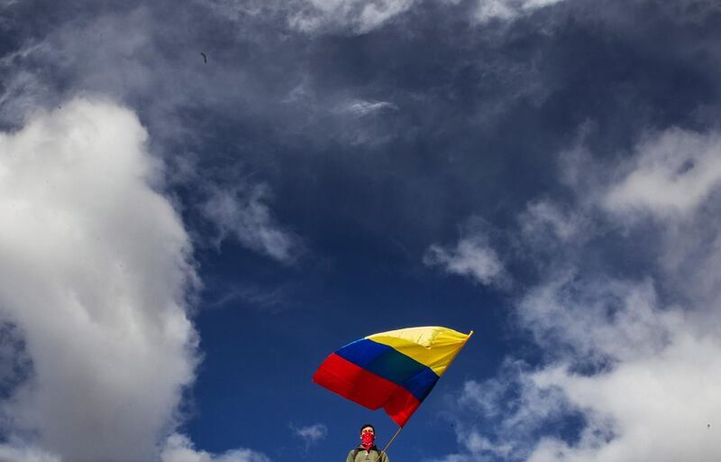 A student of the National University shows a Colombian flag in protest and solidarity to Dilan Cruz, 18, who died a night earlier from a serious head injury.  EPA