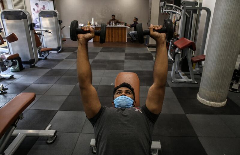 An Indian youth wearing a face mask works out in a gym in Mumbai, India. Following seven months of closures as part of the measures to fight the spread of COVID-19, from 25 October fitness enthusiasts in Maharashtra state were once again allowed into gyms and fitness centers. According to reports, India became the second worst-hit country by the spread of novel coronavirus which causes COVID-19 disease, as Indian tally is about to reach 8 million cases, only behind the United States.  EPA