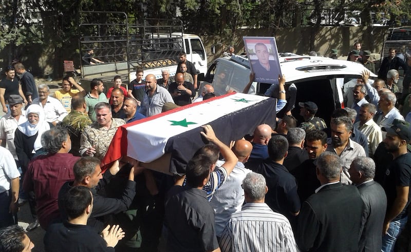(FILES) In this handout file photo taken on July 26, 2018, released by the official Syrian Arab News Agency (SANA), Syrians carry the coffin of a victim of suicide attacks during a mass funeral in the southern city of Sweida.
The Islamic State jihadist group has executed one of dozens of Druze hostages abducted from Syria's southern province of Sweida last month, a Syrian news outlet and a monitor said on August 5. IS killed the 19-year-old male student on August 2 after kidnapping more than 30 people, mostly women and children, from a village in Sweida during a deadly rampage on July 25, the head of the Sweida24 news website Nour Radwan said. / AFP PHOTO / SANA / - / RESTRICTED TO EDITORIAL USE - MANDATORY CREDIT "AFP PHOTO / SANA" - NO MARKETING NO ADVERTISING CAMPAIGNS - DISTRIBUTED AS A SERVICE TO CLIENTS