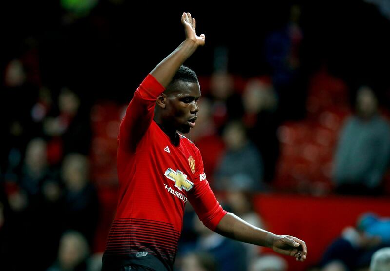 Manchester United's Paul Pogba waves to spectators as he leaves the pitch after their Premier League match in Manchester. Martin Rickett / AP Photo