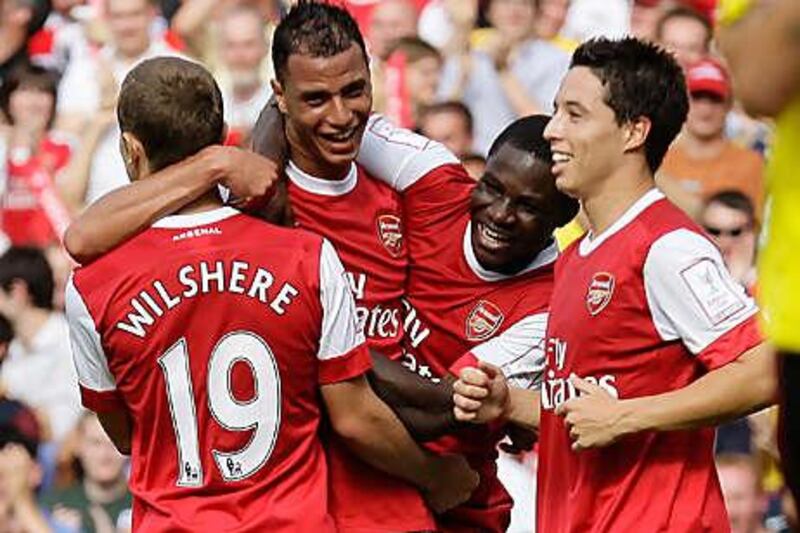 Marouane Chamakh, second left, is congratulated by his Arsenal teammates after his goal against AC Milan yesterday.