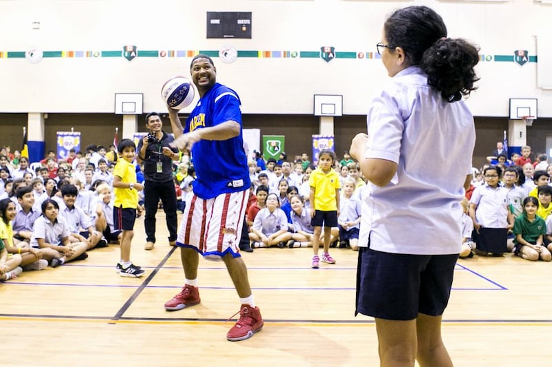 Handles from the Harlem Globetrotters shows off his basketball skills at Dubai International Academy. Reem Mohammed / The National