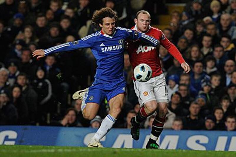 Chelsea's David Luiz, left, and Manchester United's Wayney Rooney tussle for the ball at Stamford Bridge.