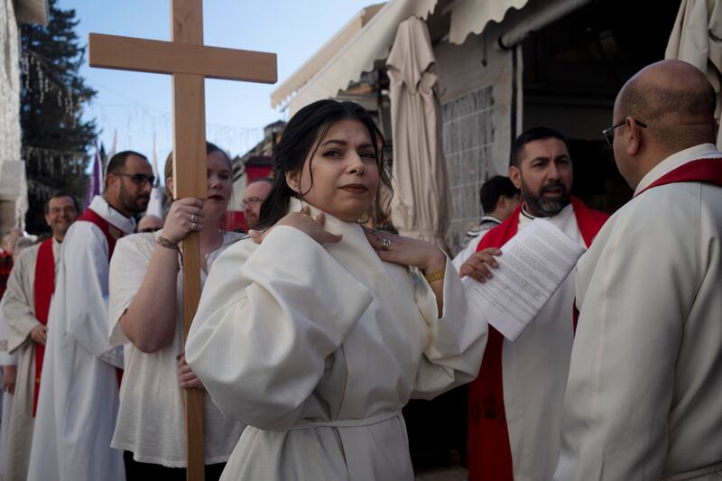 Sally Azar checks her collar before the procession for her ordination on Sunday. AP