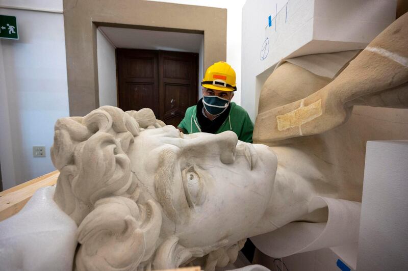 The restorers' work includes adding the cracks, fractures and abrasions to give it the same character of the current statue. EPA