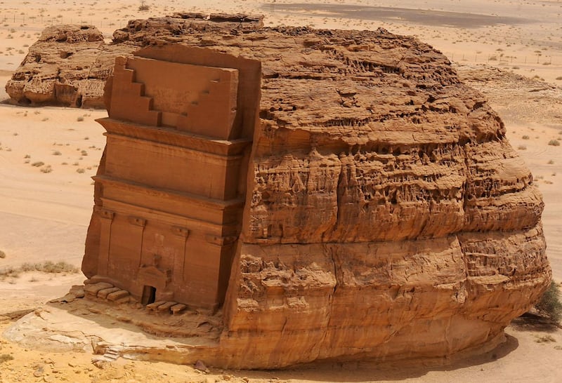 A picture taken on April 1, 2018 shows an aerial view of the Qasr al-Farid tomb (The Lonely Castle) carved into rose-coloured sandstone in Madain Saleh, a UNESCO World Heritage site, near Saudi Arabia's northwestern town of al-Ula. - Al-Ula, an area rich in archaeological remnants, is seen as a jewel in the crown of future Saudi attractions as the austere kingdom prepares to issue tourist visas for the first time -- opening up one of the last frontiers of global tourism. Saudi Crown Prince Mohammed bin Salman is set to sign a landmark agreement with Paris on April 10, 2018 for the touristic and cultural development of the northwestern site, once a crossroads of ancient civilisations. (Photo by FAYEZ NURELDINE / AFP)