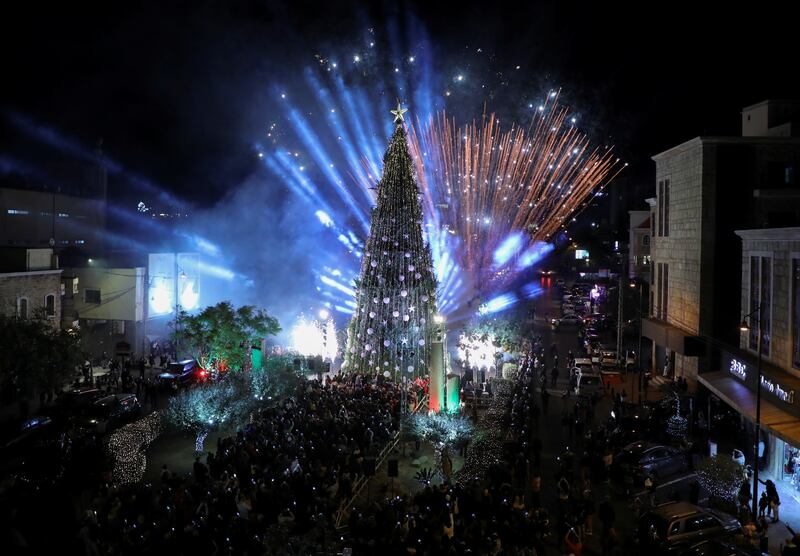 Fireworks explode as the tree's lights are turned on. Reuters