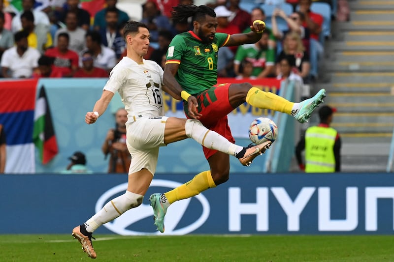 Serbia midfielder Sasa Lukic fights for the ball with Cameroon midfielder Andre-Frank Zambo Anguissa. AFP