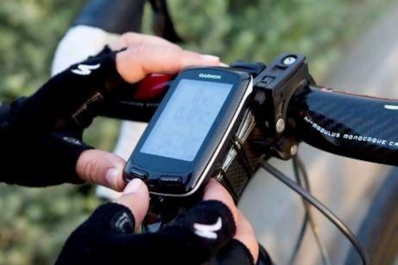 Victoria Norvall adjusts the settings on her Garmin Edge before she sets off on her morning bicycle ride around Nad Al Sheba. Victoria has been using the GPS device for about a month and is very happy with it. Razan Alzayani / The National