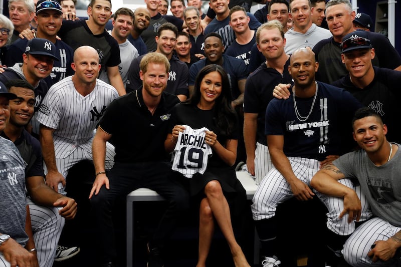 Prince Harry, Duke of Sussex and Meghan, Duchess of Sussex, pose for a photo with the New York Yankees before their game against the  Boston Red Sox at London Stadium on June 29, 2019 in London, England. The game was in support of the Invictus Games Foundation. Getty Images