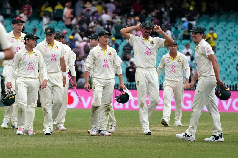 Australia's players walk off at  the end of play. AP