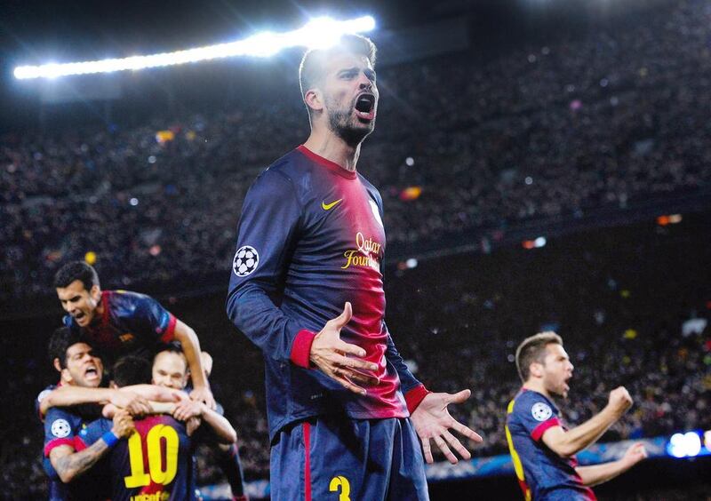 Gerard Pique of Barcelona celebrates after Lionel Messi scored his team's second goal during the Uefa Champions League round of 16 second leg against AC Milan at the Camp Nou Stadium on March 12, 2013, in Barcelona, Spain. David Ramos / Getty Images