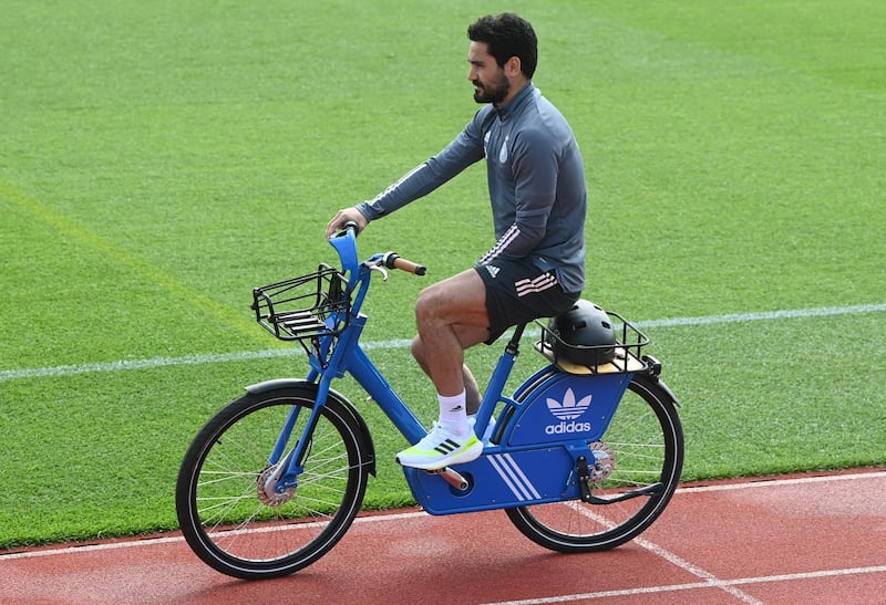 Germany midfielder Ilkay Gundogan arrives on a bicycle. AFP