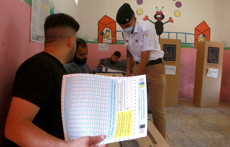 An Iraqi federal policeman casts his vote in Baghdad. AP Photo
