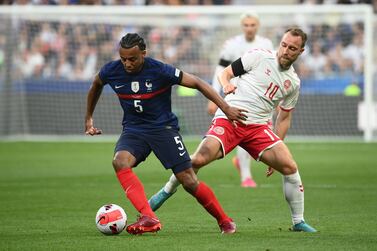 France's defender Jules Kounde (L) fights for the ball with Denmark's midfielder Christian Eriksen during the UEFA Nations League - League A Group 1 first leg football match between France and Denmark at the Stade de France in Saint-Denis, north of Paris, on June 3, 2022.  (Photo by Franck FIFE  /  AFP)