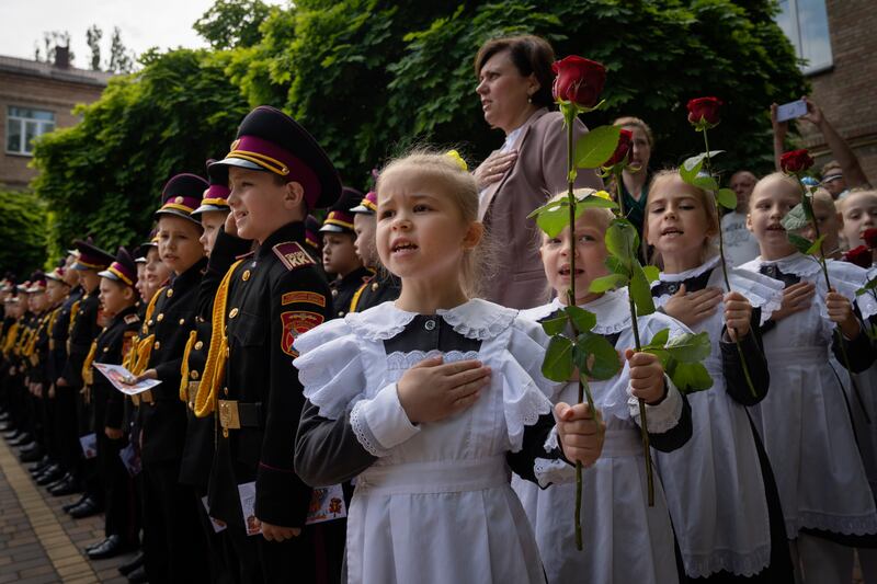 Young cadets sing the national anthem during a graduation ceremony at a cadet lyceum in Kyiv in June