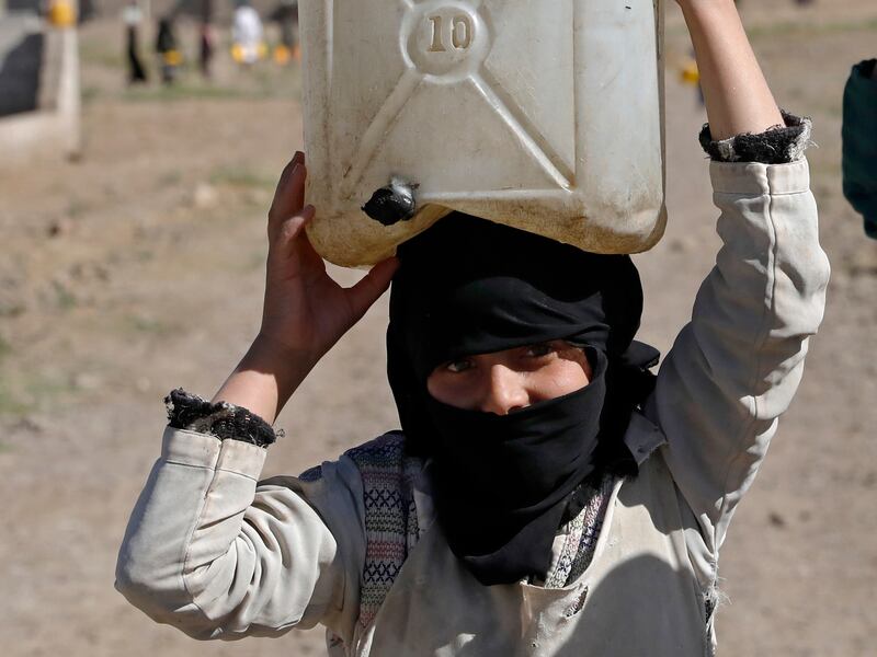 A woman carries a water container on the outskirts of Sana'a on Tuesday. Yemen has one of the lowest supplies of freshwater in the world. EPA
