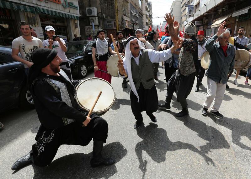 Supporters of the Lebanese Communist party perform a traditional dance as they take part in a May Day rally in Beirut. Anwar Amro / AFP Photo