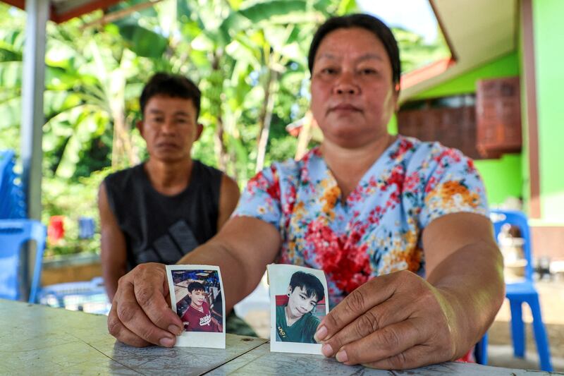 The parents of Natthaporn, who was working in Israel and was taken hostage by Hamas on October 7, show photos of him at their house in Nakhon Phanom, Thailand. Reuters