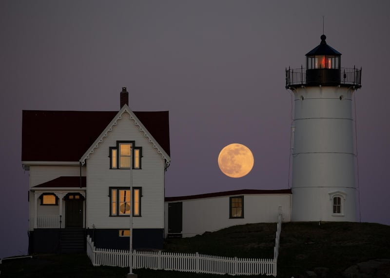 A full pink supermoon is seen rising behind the Nubble Lighthouse on Cape Neddick, in York, Maine, US. EPA