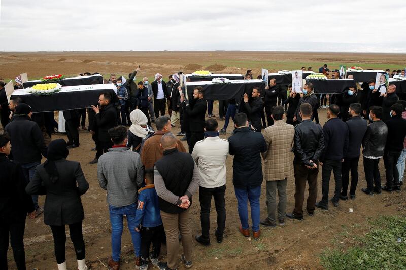 Mourners line the route as coffins holding the remains of Yazidis slain by ISIS are taken for burial. Reuters