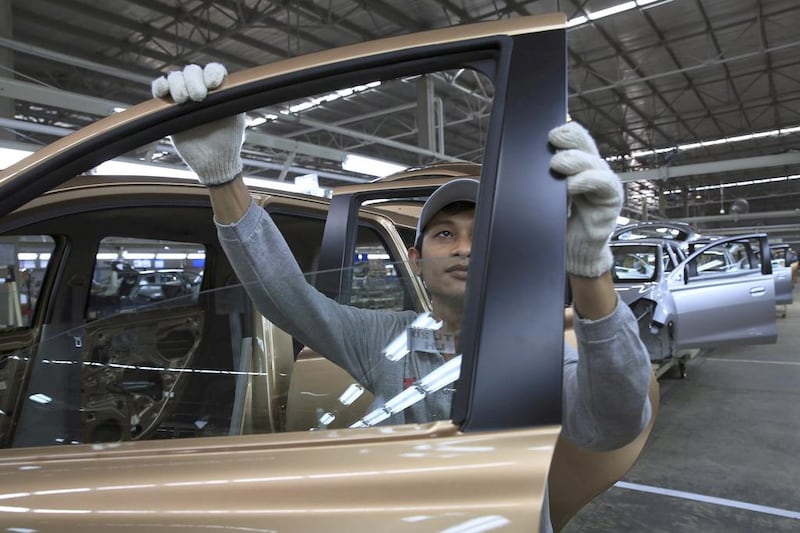 A workers inspects a Datsun Go+ at an assembly line at the Nissan Indonesia factory. Beawiharta / Reuters