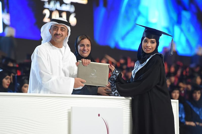 Sheikh Abdullah bin Zayed presents an awared with Sheikha Lubna looking on.